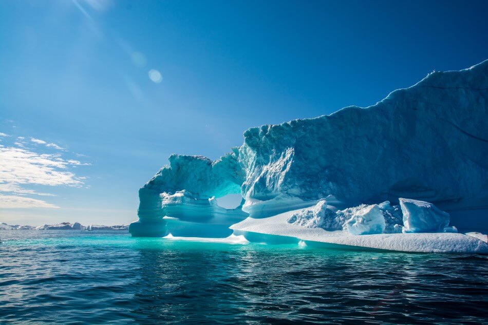 An interesting arch shaped iceberg formation in Greenland, in the Arctic Ocean.