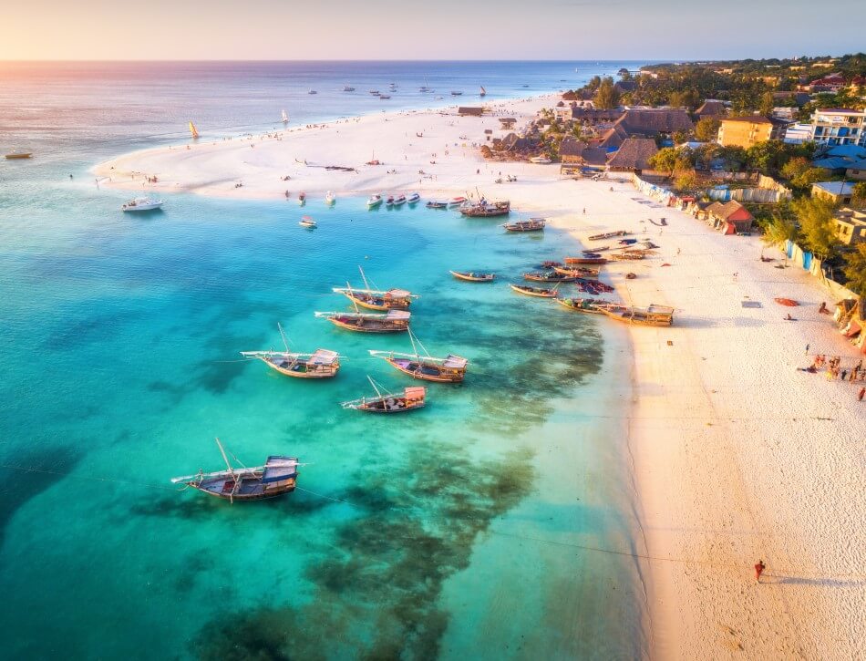 Aerial view of the fishing boats on tropical sea coast in Zanzibar, Africa, overlooking the Indian Ocean.